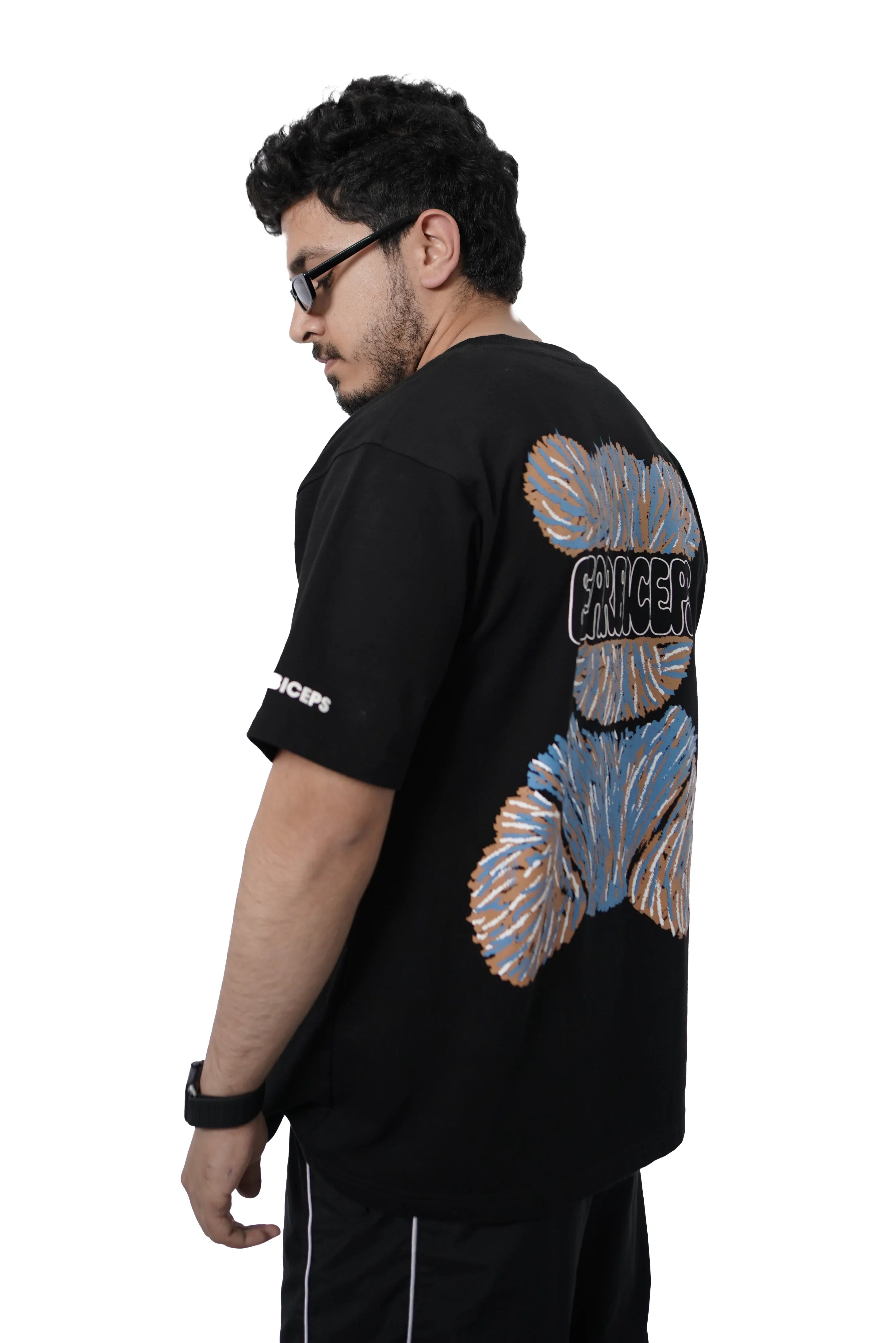 Person wearing BEARPACK black t-shirt with colorful bear designs on the back, standing against a white background